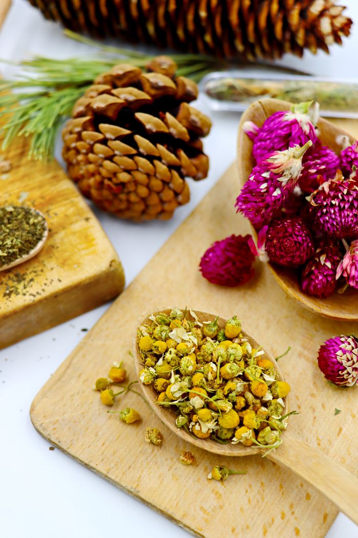 Crafting Captivating Headlines: Your awesome post title goes here Wooden boards display chamomile and herbal tea ingredients in a rustic, earthy setting.